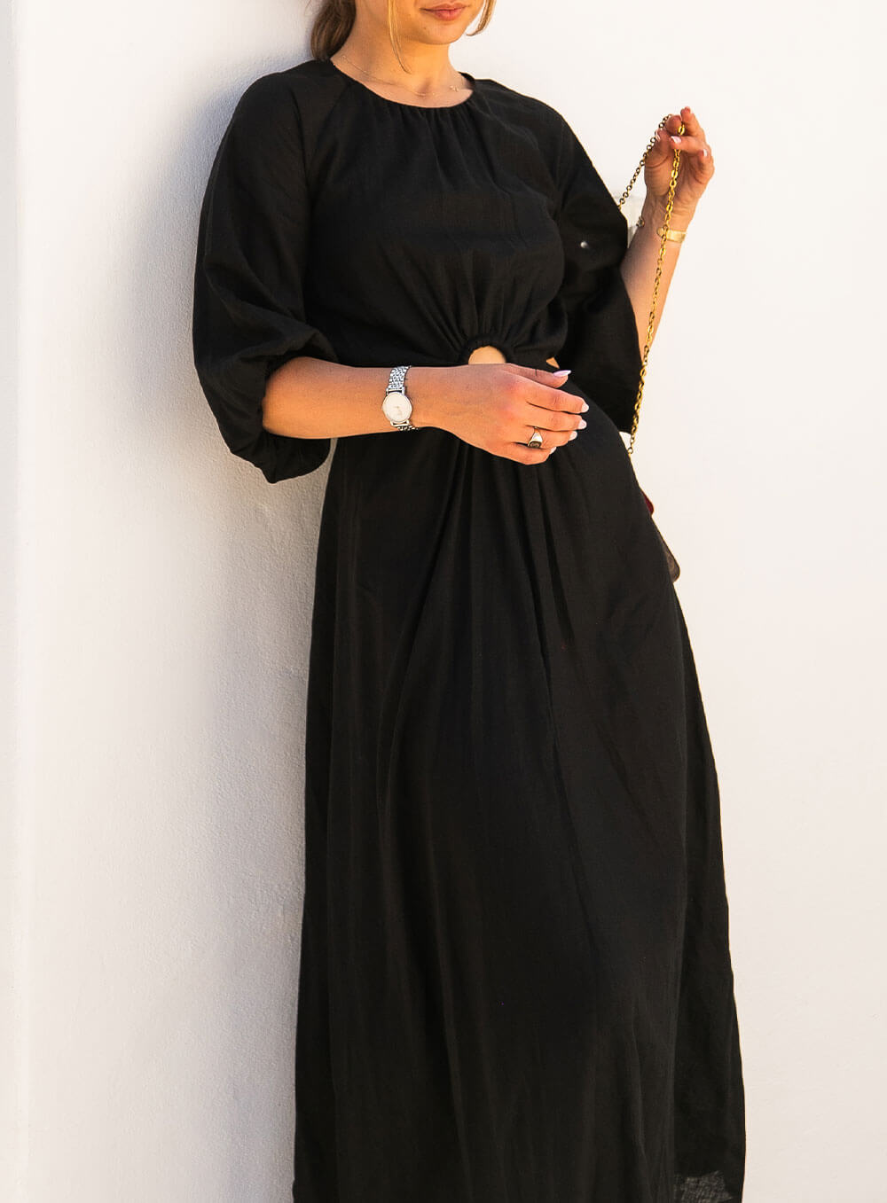 The Margot Linen mid length dress in black features an invisible zip in centre back, strategically placed side cut outs. Circle detail centre front.
