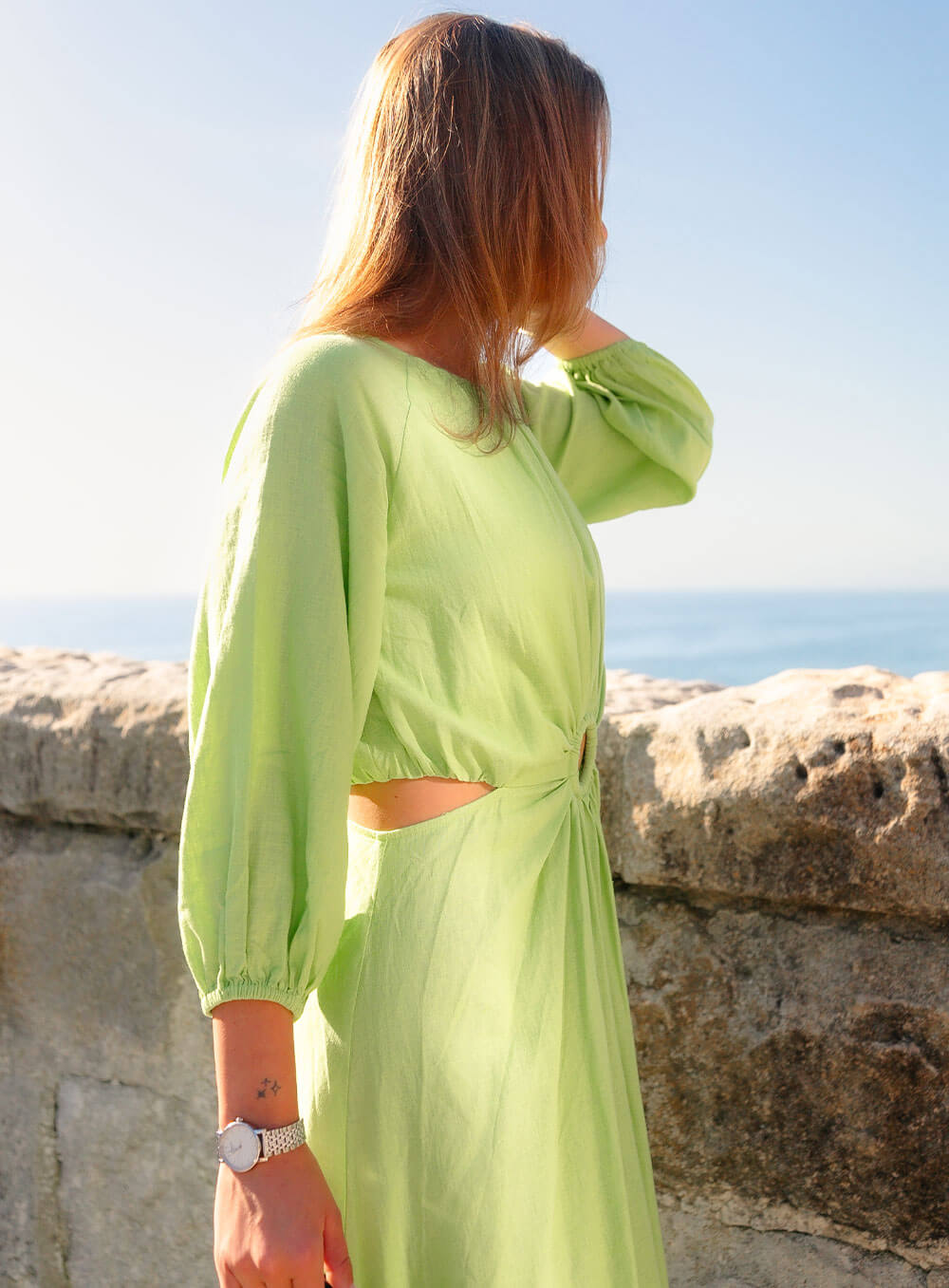 The Margot Linen mid length dress in lime features an invisible zip in centre back, strategically placed side cut outs. Circle detail centre front.