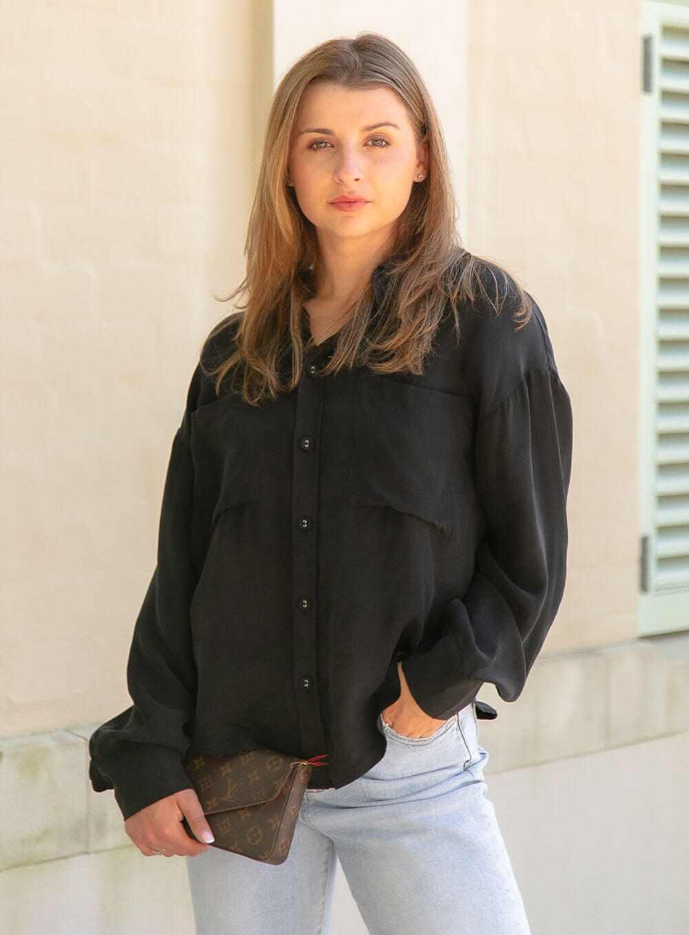 The Sienna Cupro shirt in black is a long sleeve soft velvet feeling long sleeve shirt with 2 chest pockets, scoop hem and self fabric buttons down the front. 