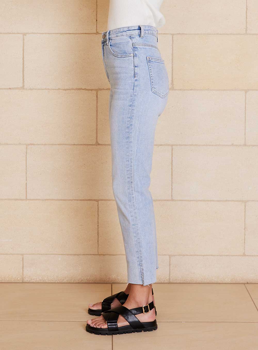 The High Mum Jean in clear waters colour is super high rise, kick leg and cropped, raw edge, zip fly fastening and stretch denim in 100% cotton