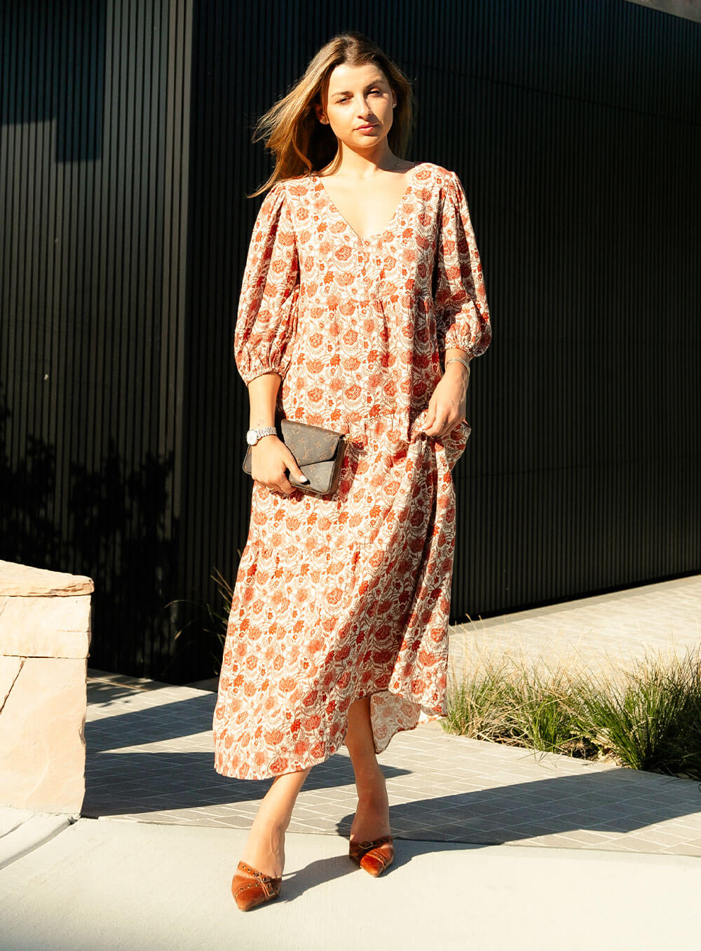 The Charlize linen dress has an all over brownie red print on a cream coloured background. It's lined, elasticated Sleeve, tiered style and front bodice detailing