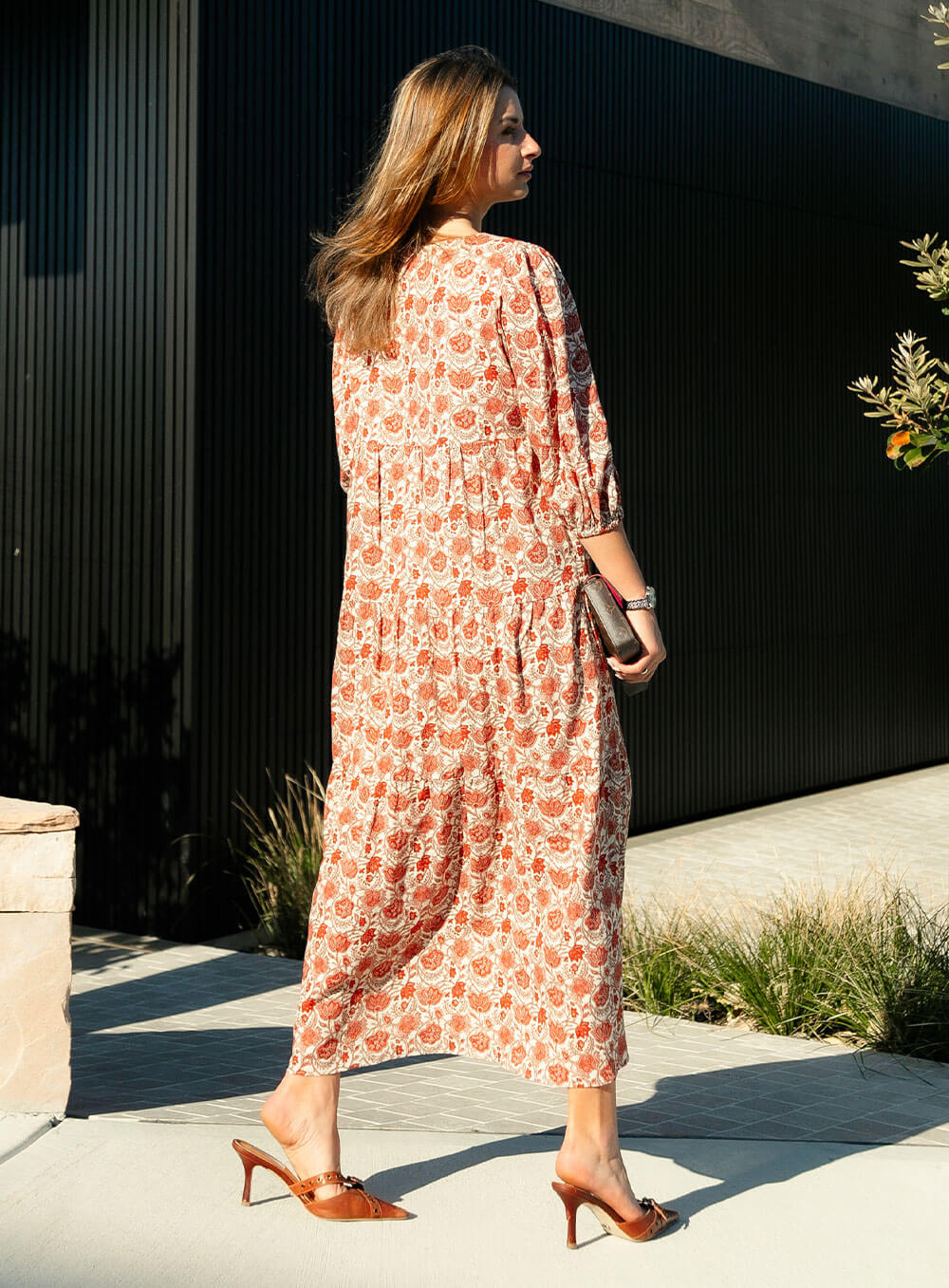 The Charlize linen dress has an all over brownie red print on a cream coloured background. It's lined, elasticated Sleeve, tiered style and front bodice detailing