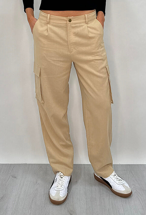 Athena Linen Cargo Pant in beige is 100% Linen, elastic waistband at back, belt loops, slightly tapered towards the hem, 2 Pockets at back, 2 Pockets on side leg