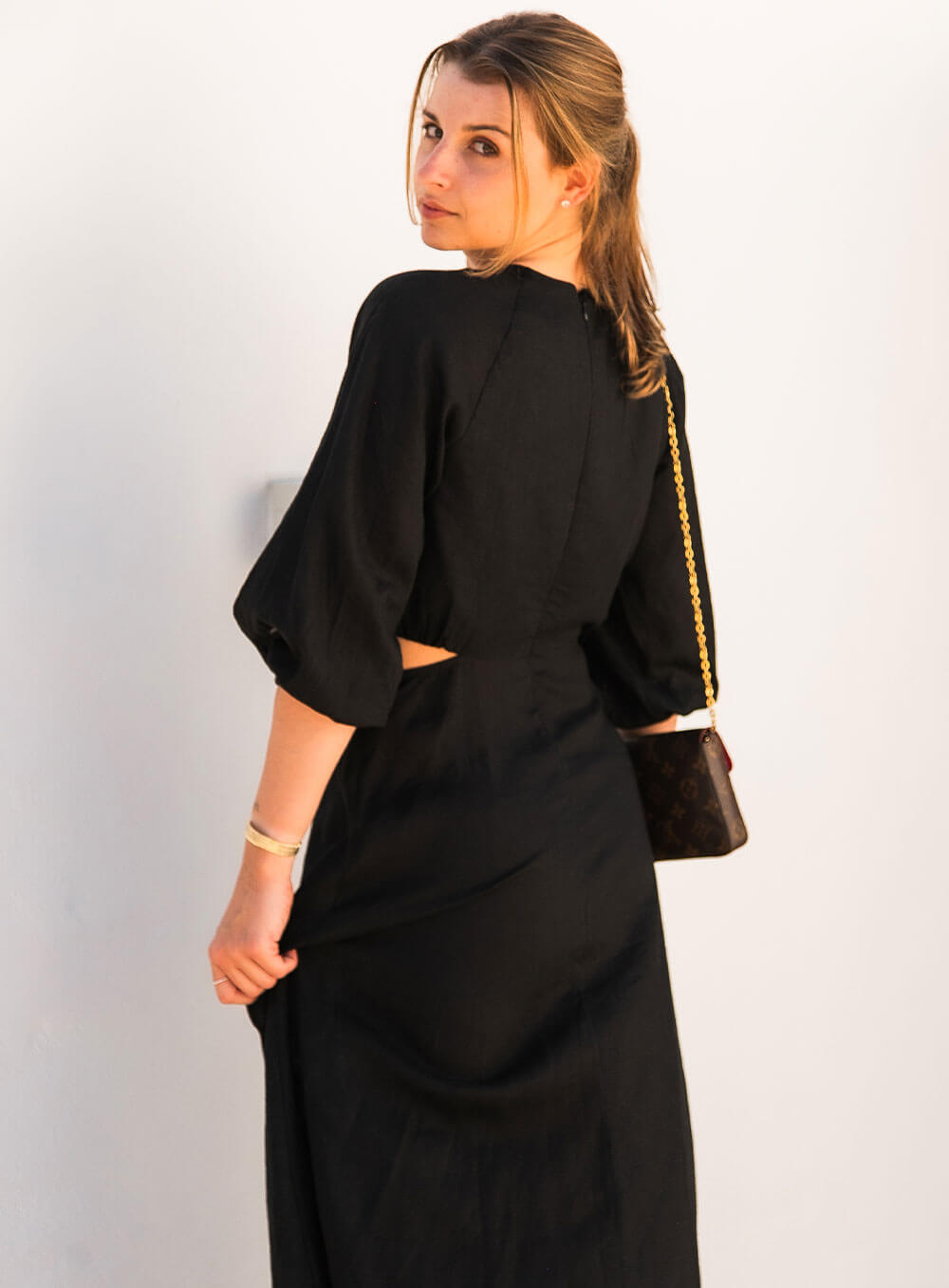 The Margot Linen mid length dress in black features an invisible zip in centre back, strategically placed side cut outs. Circle detail centre front.