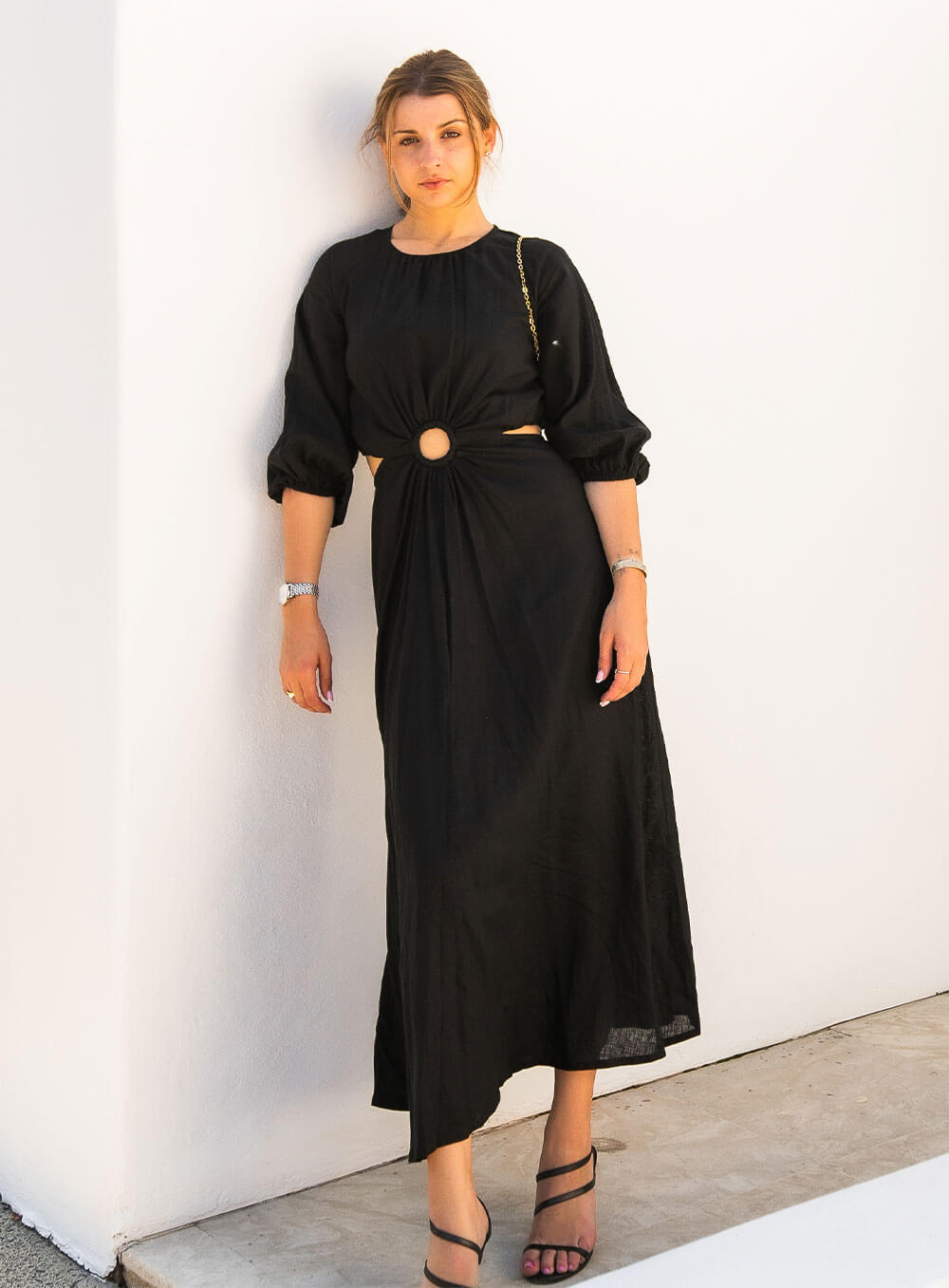 The Margot Linen mid length dress in black features an invisible zip in centre back, strategically placed side cut outs. Circle detail centre front.