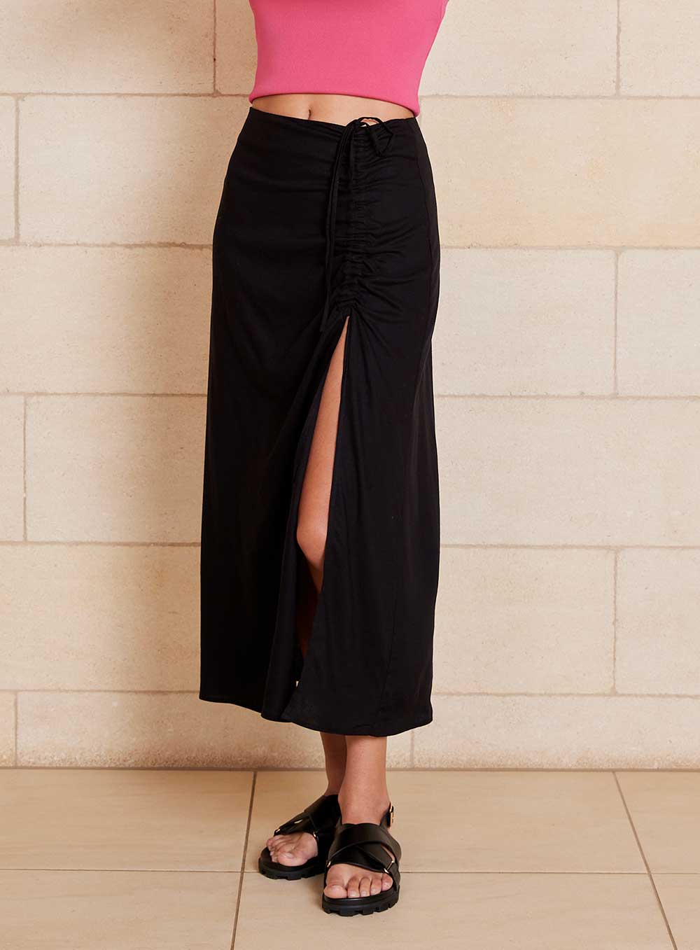 The Lily Skirt in black features a ruched split detailing that adds both shape and texture, functional ruching with tie leg splits and invisible zip back seam.