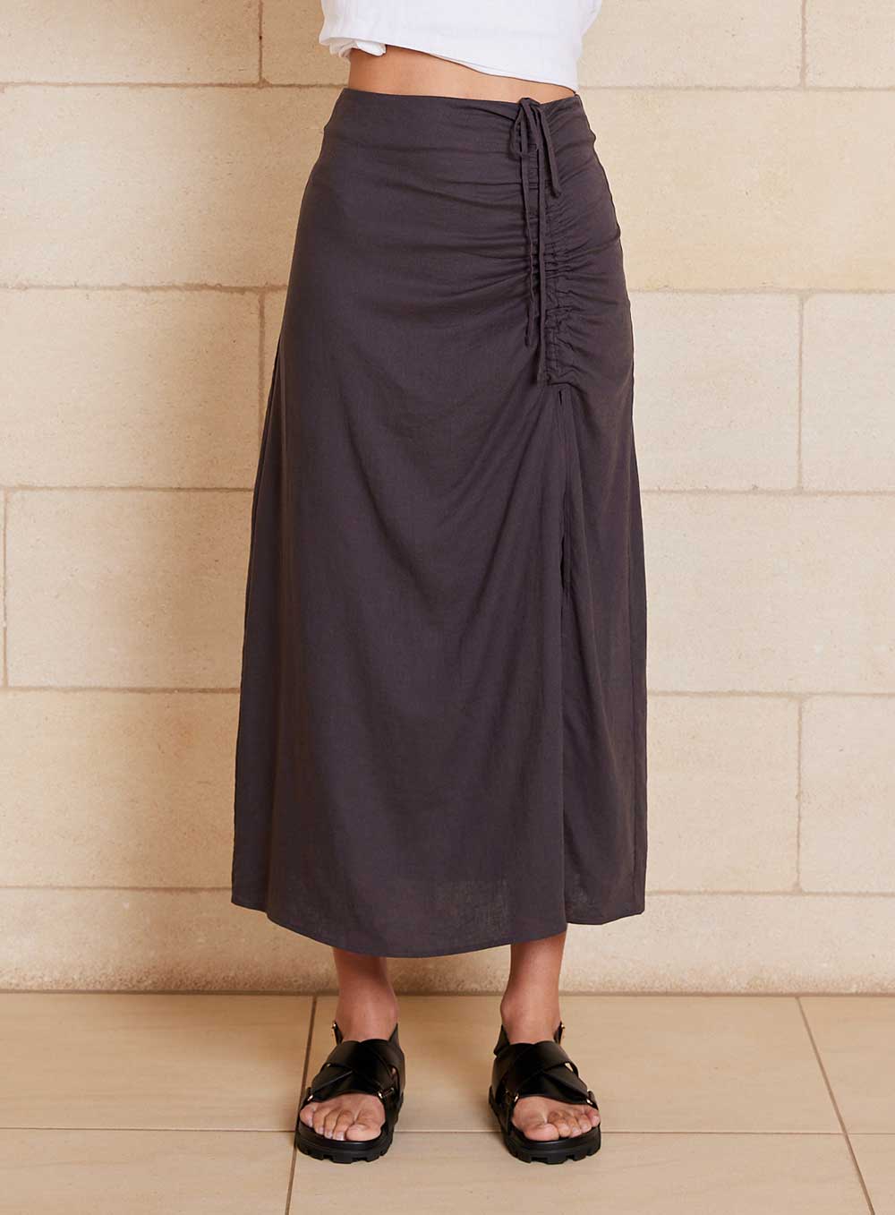 The Lily Skirt in charcoal features a ruched split detailing that adds both shape and texture, functional ruching with tie leg splits and invisible zip back seam.