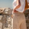 Athena Linen Cargo Pant in beige is 100% Linen, elastic waistband at back, belt loops, slightly tapered towards the hem, 2 Pockets at back, 2 Pockets on side leg