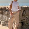 Athena Linen Cargo Pant in beige is 100% Linen, elastic waistband at back, belt loops, slightly tapered towards the hem, 2 Pockets at back, 2 Pockets on side leg