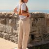 Athena Linen Cargo Pant in beige is 100% Linen, elastic waistband at back, belt loops, slightly tapered towards the hem, 2 Pockets at back, 2 Pockets on side leg