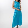 Bella Dress in Aqua features a gathered neckline, sleeveless, small cut outs at top and side of hips, with a a small ring above belly button and midi in length with a flowing skirt.