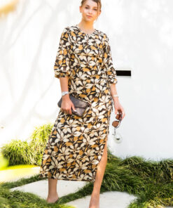 This mid length dress has asymmetric cut outs with drawstring, split in side seam at the lower leg and rouched neck detail