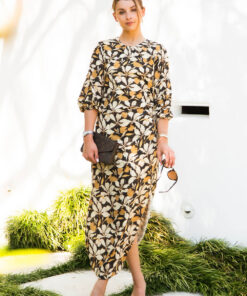 This mid length dress has asymmetric cut outs with drawstring, split in side seam at the lower leg and rouched neck detail