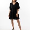 The Eleanor mini dress in black features a flowing layered a line shape with draping linen/viscose fabric, puff 3/4 sleeves with elastic cuff which can be pushed up to the elbow, a dropped v shape neckline with a square finish.