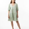 The Eleanor mini dress in sage features a flowing layered a line shape with draping linen/viscose fabric, puff 3/4 sleeves with elastic cuff which can be pushed up to the elbow, a dropped v shape neckline with a square finish.