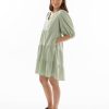 The Eleanor mini dress in sage features a flowing layered a line shape with draping linen/viscose fabric, puff 3/4 sleeves with elastic cuff which can be pushed up to the elbow, a dropped v shape neckline with a square finish.