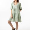 The Eleanor mini dress in sage features a flowing layered a line shape with draping linen/viscose fabric, puff 3/4 sleeves with elastic cuff which can be pushed up to the elbow, a dropped v shape neckline with a square finish.