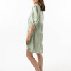The Eleanor mini dress in sage features a flowing layered a line shape with draping linen/viscose fabric, puff 3/4 sleeves with elastic cuff which can be pushed up to the elbow, a dropped v shape neckline with a square finish.