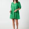 The Eleanor mini dress in green features a flowing layered a line shape with draping linen/viscose fabric, puff 3/4 sleeves with elastic cuff which can be pushed up to the elbow, a dropped v shape neckline with a square finish.