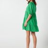 The Eleanor mini dress in green features a flowing layered a line shape with draping linen/viscose fabric, puff 3/4 sleeves with elastic cuff which can be pushed up to the elbow, a dropped v shape neckline with a square finish.