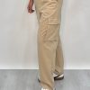 Athena Linen Cargo Pant in beige is 100% Linen, elastic waistband at back, belt loops, slightly tapered towards the hem, 2 Pockets at back, 2 Pockets on side leg