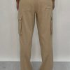 Athena Linen Cargo Pant in beige is 100% Linen, elastic waistband at back, belt loops, slightly tapered towards the hem, 2 Pockets at back, 2 Pockets on side leg