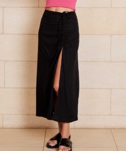The Lily Skirt in black features a ruched split detailing that adds both shape and texture, functional ruching with tie leg splits and invisible zip back seam.