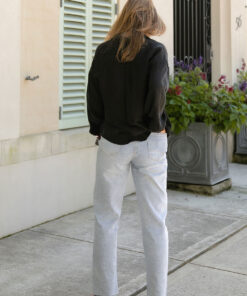 The Sienna Cupro shirt in black is a long sleeve soft velvet feeling long sleeve shirt with 2 chest pockets, scoop hem and self fabric buttons down the front.