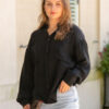 The Sienna Cupro shirt in black is a long sleeve soft velvet feeling long sleeve shirt with 2 chest pockets, scoop hem and self fabric buttons down the front. 