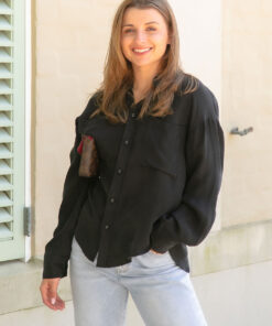 The Sienna Cupro shirt in black is a long sleeve soft velvet feeling long sleeve shirt with 2 chest pockets, scoop hem and self fabric buttons down the front. 